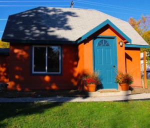 exterior of orange house vacation rental with blue door